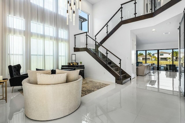 staircase with a healthy amount of sunlight and a towering ceiling