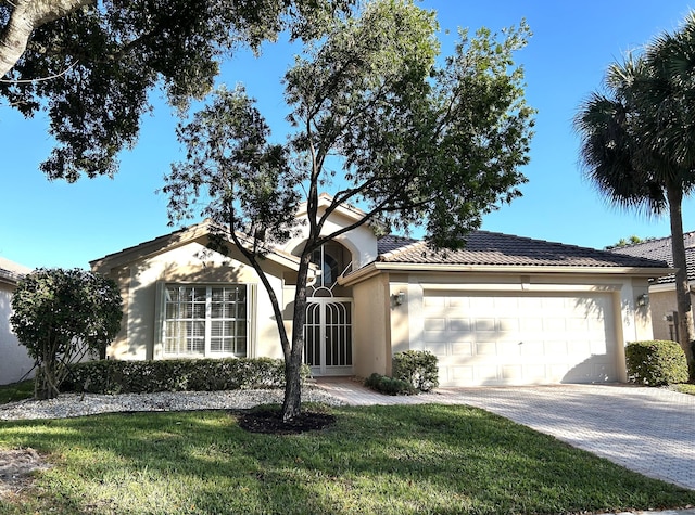 ranch-style house with a front lawn and a garage