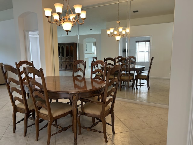 dining space with a chandelier and light tile patterned floors