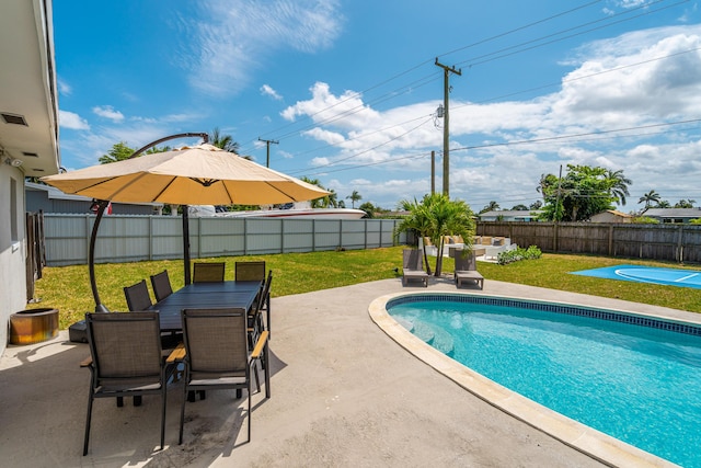 view of swimming pool with a patio, outdoor dining space, a lawn, and a fenced backyard