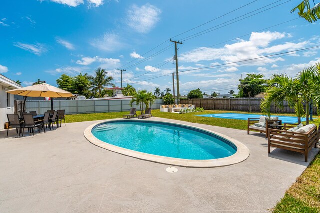 view of pool with a fenced in pool, a patio area, a yard, and a fenced backyard