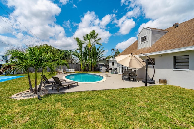 view of swimming pool featuring a fenced in pool, fence private yard, a patio area, and a lawn