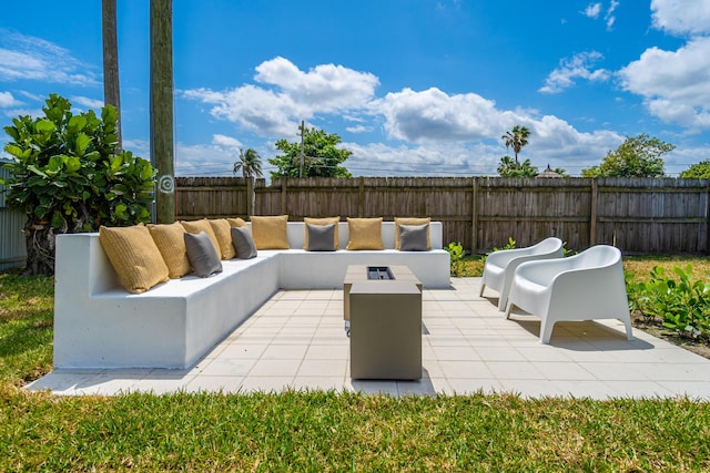 view of patio / terrace featuring a fenced backyard and an outdoor living space with a fire pit