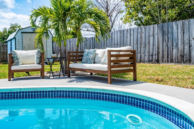 view of swimming pool featuring a fenced in pool, an outdoor structure, a storage unit, and fence