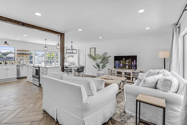 living area with beamed ceiling and recessed lighting