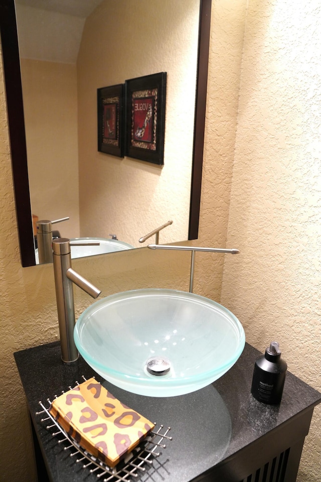 bathroom featuring sink and vaulted ceiling