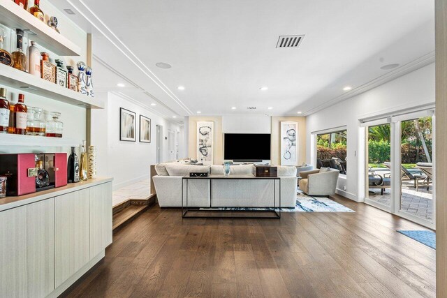 living room featuring wood-type flooring and ornamental molding