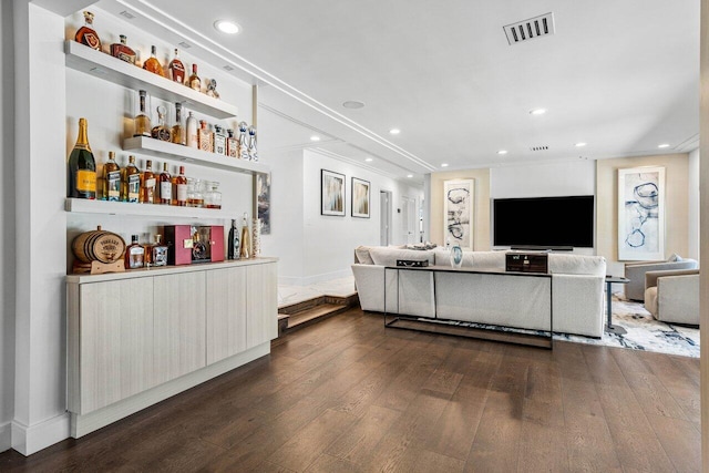 living room featuring dark hardwood / wood-style flooring and bar