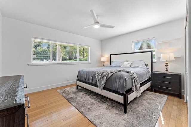 bedroom with ceiling fan and light wood-type flooring