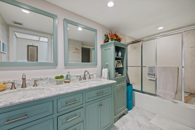 bathroom featuring vanity and bath / shower combo with glass door