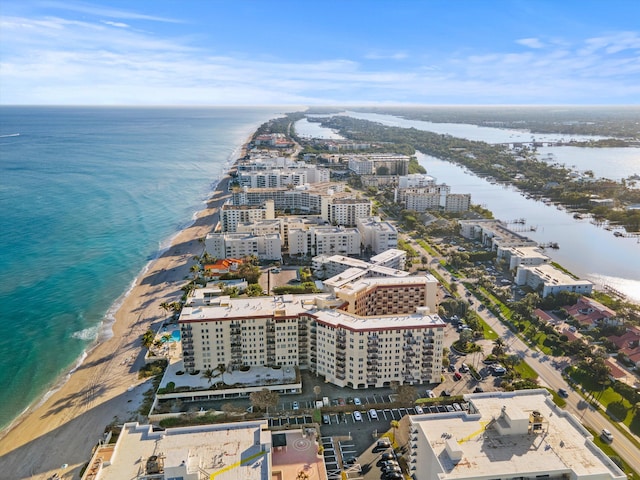 drone / aerial view featuring a beach view and a water view