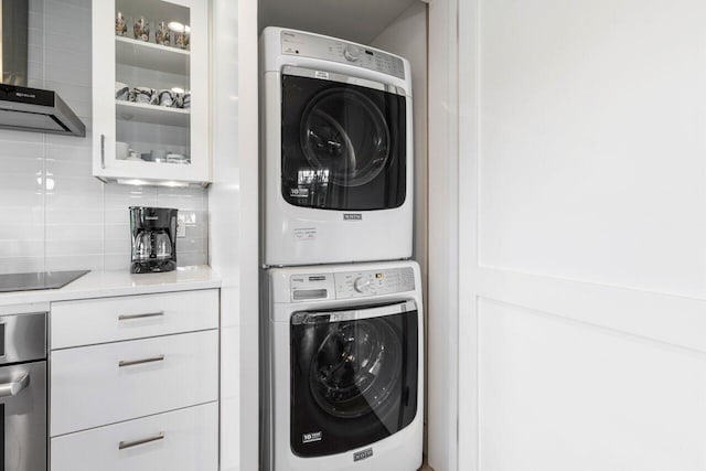 laundry area featuring stacked washer and clothes dryer