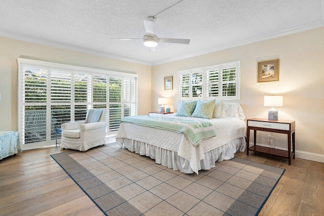 bedroom featuring hardwood / wood-style flooring, ceiling fan, ornamental molding, and a textured ceiling