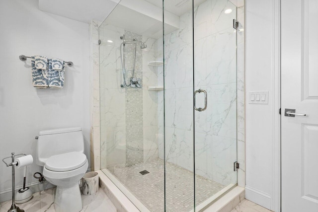 bathroom with toilet and a shower with shower door