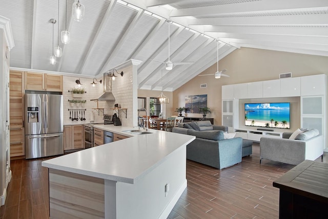 kitchen with white cabinets, sink, ceiling fan, appliances with stainless steel finishes, and beamed ceiling