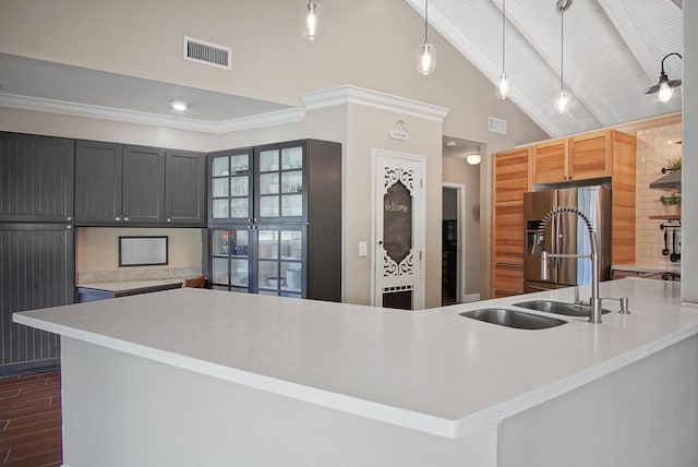 kitchen featuring ceiling fan, sink, hanging light fixtures, stainless steel fridge with ice dispenser, and beamed ceiling