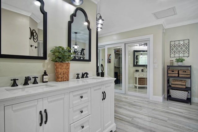 bathroom featuring hardwood / wood-style flooring, vanity, and ornamental molding