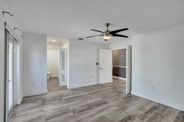 empty room featuring ceiling fan and light hardwood / wood-style floors