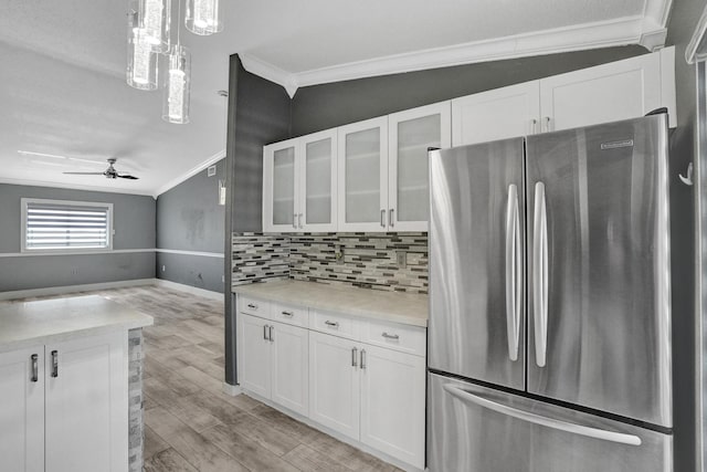 kitchen featuring white cabinetry, stainless steel fridge, crown molding, and ceiling fan