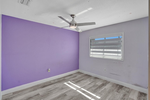 spare room with light hardwood / wood-style flooring and ceiling fan