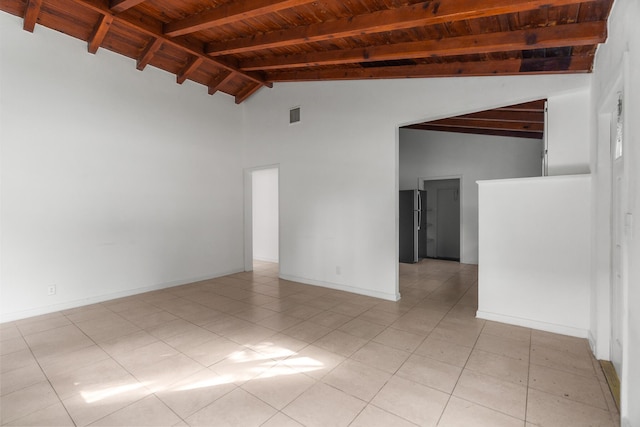 tiled spare room with beam ceiling, high vaulted ceiling, and wooden ceiling