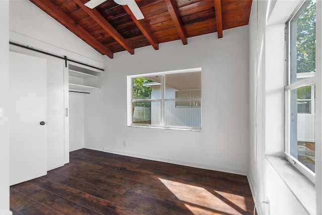 unfurnished room featuring wooden ceiling, dark wood-type flooring, lofted ceiling with beams, ceiling fan, and a barn door