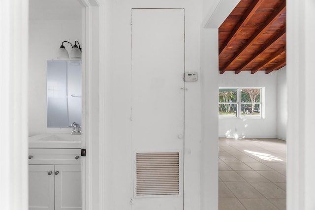 bathroom featuring tile patterned floors, vanity, vaulted ceiling with beams, and wood ceiling