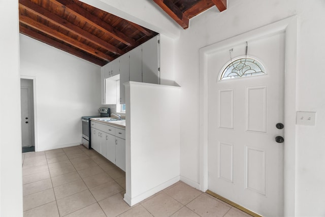 tiled foyer featuring lofted ceiling with beams, wooden ceiling, and sink