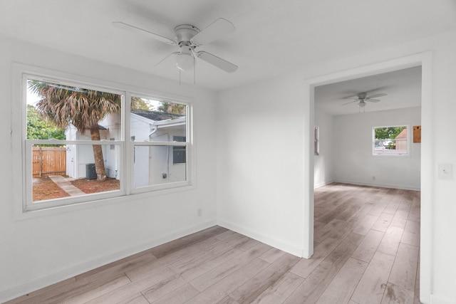 spare room with ceiling fan and light wood-type flooring