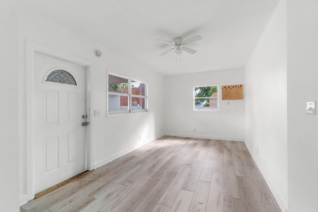 foyer with ceiling fan and light hardwood / wood-style flooring