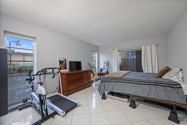 bedroom with light tile patterned floors and a textured ceiling