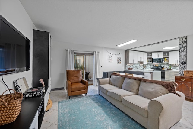 living room featuring light tile patterned floors and a textured ceiling