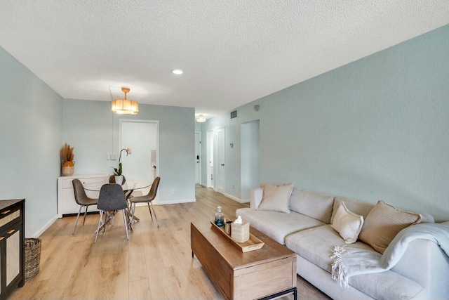 760 SE 2nd Ave Unit C203, Deerfield Beach, FL 33441 - living area with light wood-style flooring, a textured ceiling, recessed lighting, and baseboards
