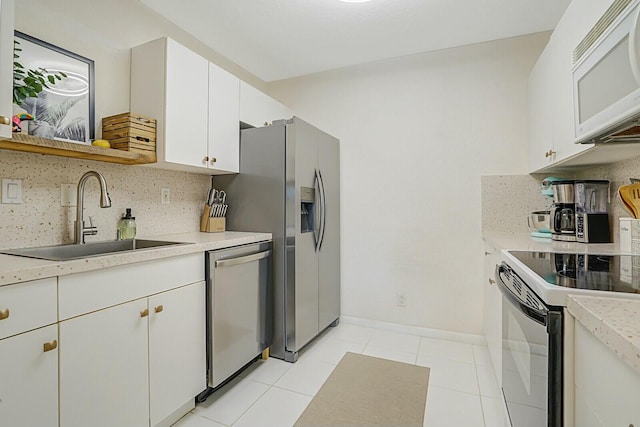 760 SE 2nd Ave Unit C203, Deerfield Beach, FL 33441 - kitchen featuring stainless steel appliances, a sink, backsplash, and light countertops