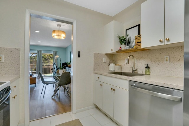760 SE 2nd Ave Unit C203, Deerfield Beach, FL 33441 - kitchen featuring dishwasher, a sink, decorative backsplash, white cabinets, and baseboards