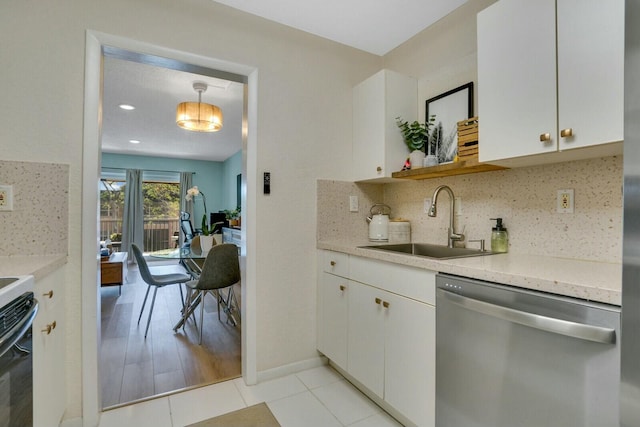 kitchen featuring pendant lighting, dishwasher, sink, decorative backsplash, and white cabinetry