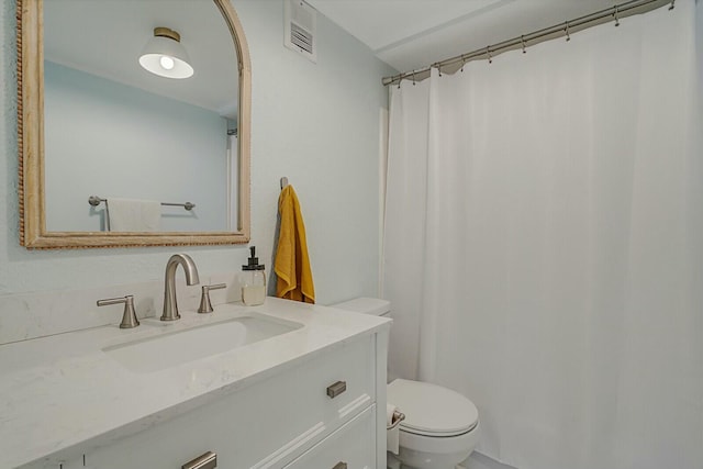 bathroom featuring vanity and toilet