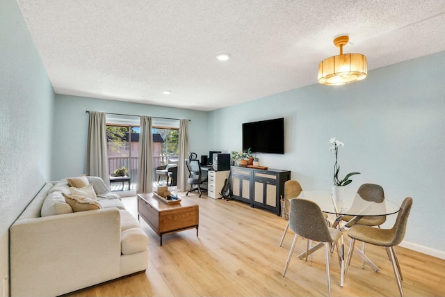 living room featuring hardwood / wood-style floors and a textured ceiling