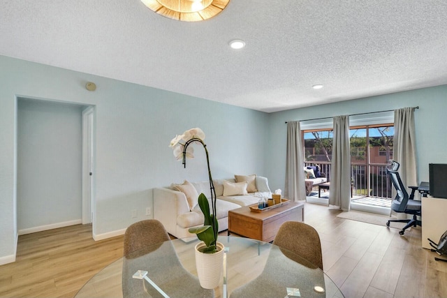 interior space featuring a textured ceiling and light hardwood / wood-style floors