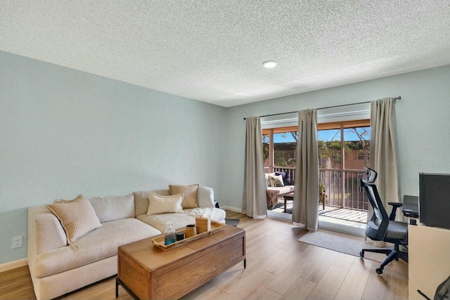 office featuring light hardwood / wood-style floors and a textured ceiling