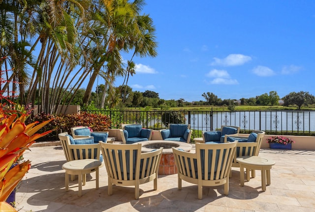 view of patio with a water view and outdoor lounge area