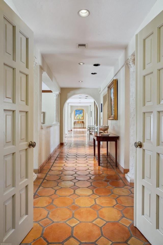 hall featuring light tile patterned floors