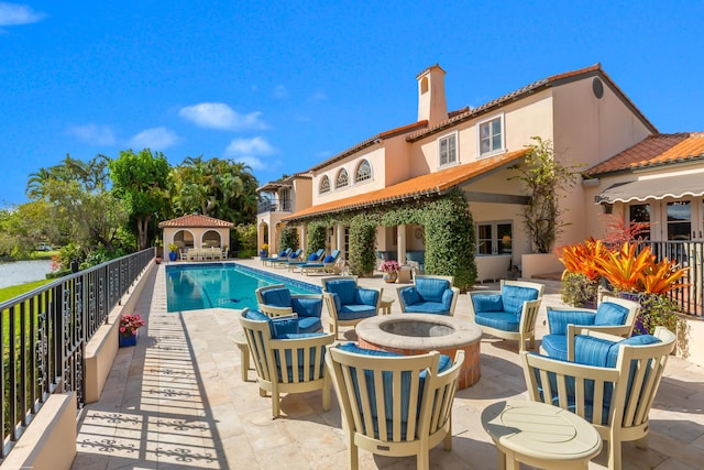 view of pool featuring a patio area and an outdoor fire pit