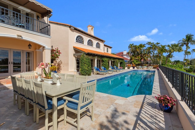 view of pool featuring a patio and french doors