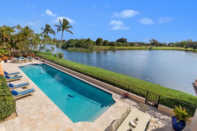 view of swimming pool featuring a water view and a patio area