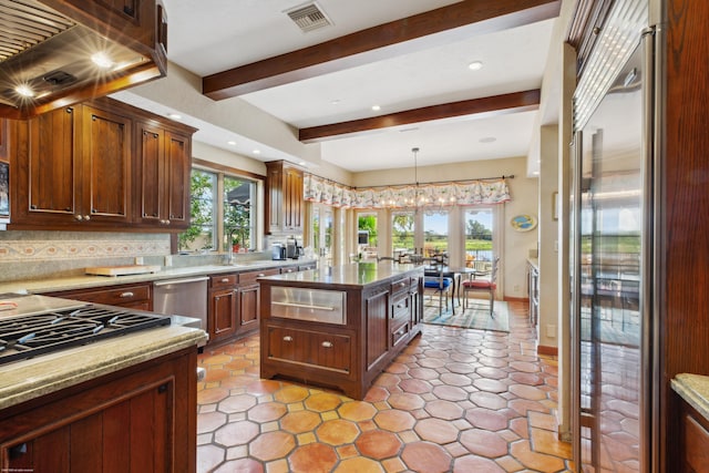 kitchen featuring tasteful backsplash, a wealth of natural light, stainless steel appliances, and a kitchen island