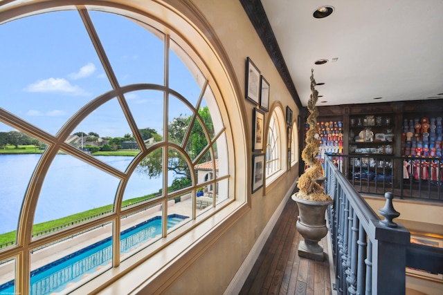 interior space with a water view and hardwood / wood-style floors