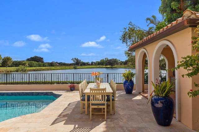 exterior space with a water view and a patio