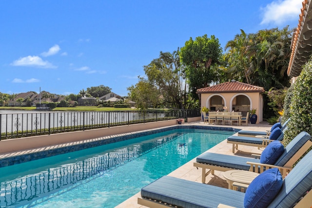 view of pool with an outbuilding and a patio area