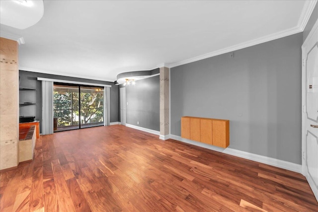 unfurnished living room with wood-type flooring and crown molding